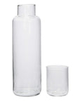 The Creative Co-op DF3660 Decanter With Glass is a stylish 32 oz clear glass set with a wide-neck carafe and a small cylindrical drinking glass, both empty and displayed against a plain white background.