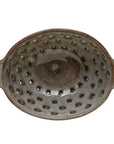 The Creative Co-op Berry Bowl with Glaze is an oval stoneware bowl with two side handles, multiple drainage holes, and a speckled brown and gray reactive glaze finish.