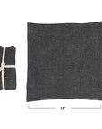 Two Creative Co-op Stonewashed Linen Napkins from the S/4 set, shown in charcoal—one folded and tied with cotton tape, the other flat—each 18" wide, displayed on a white background.