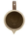 A top-down view of the Creative Co-op Pitcher w/ Stripes, featuring a beige stoneware body with a pointed spout and brown handle, isolated on a white background.