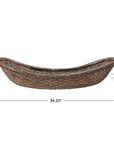 The Creative Co-op Woven Wicker Vintage basket features a long, oval shape with raised ends, an antique finish, and measures 34.25" L x 19.5" W x 8.5" H—perfect as a decorative accent for your home.