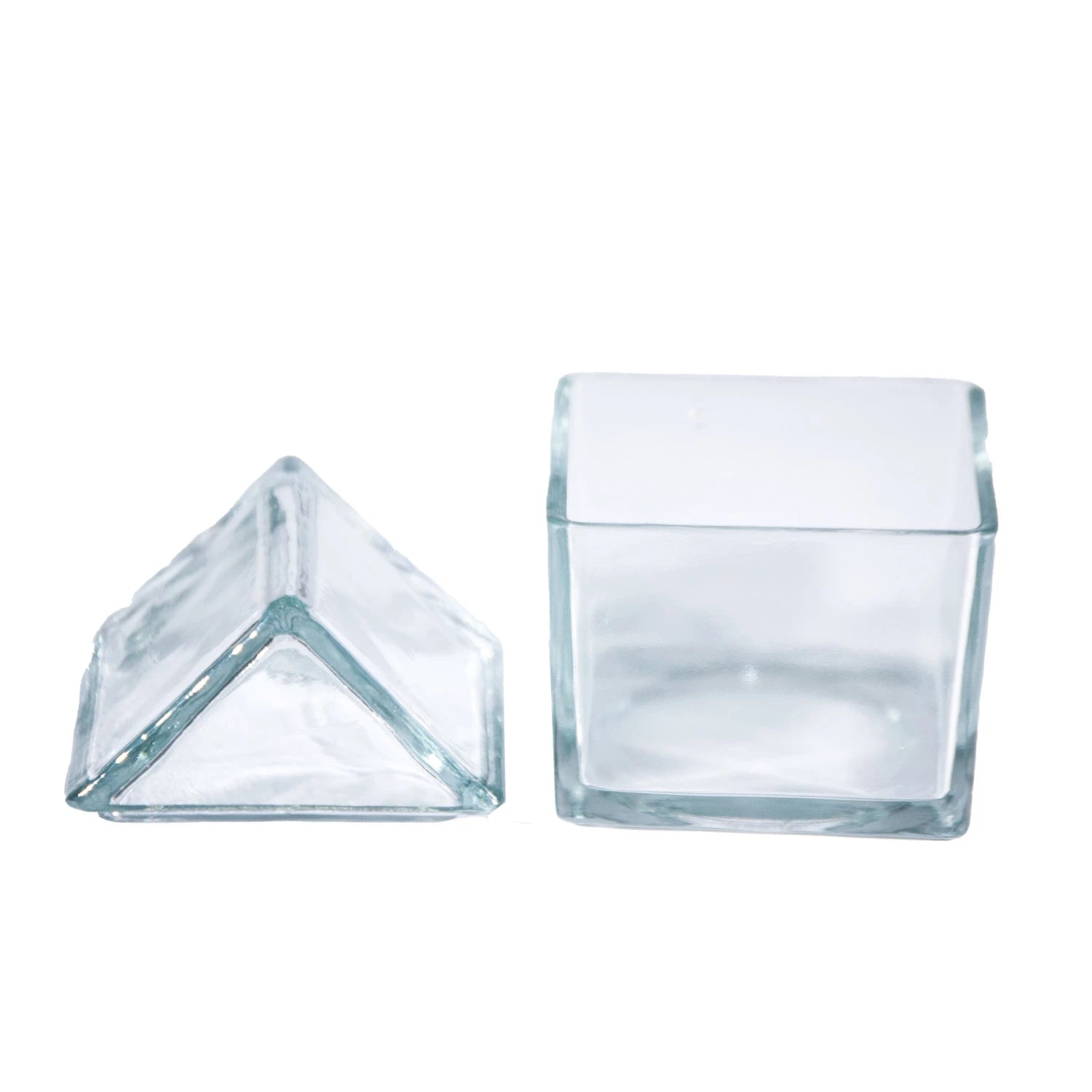 The Creative Co-op Glass House Shaped Jar with Lid is shown empty and transparent, with its house-shaped glass lid placed beside it on a white background.