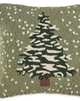 The Faire Christmas Flurries Frosted Tree Pillow is a hand-hooked wool pillow featuring a snow-covered tree and falling snowflakes on green—perfect for cozy holiday decor.