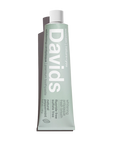 A mint green tube of Faire Davids Toothpaste stands upright. The recyclable metal tube highlights whitening, antiplaque, fresh breath, fluoride-free, sulfate-free benefits, and a peppermint flavor.