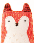 The Faire Fox Embroidery Kit lets you craft a handmade plush fox with screen printed fabric, featuring a red-orange body, white face and chest, black stitched nose and eyes, plus textured embroidery details.