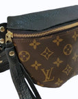 The Faire Upcycled Belt Bag features brown canvas with a classic monogram pattern, gold zipper, black leather accents, and a black leather strap.