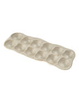 The Indaba 4-7207 Homestead Egg Holder is a beige ceramic tray with twelve rounded slots in two rows of six—ideal as a stylish kitchen accessory or practical egg holder.