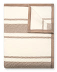 The Faire Dockside Stripe Blanket features wide light brown stripes on a cream base with solid light brown edging—one corner flipped to showcase the reverse—making it a stylish addition for coastal chic vibes in any room.
