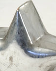 The Zentique Distressed Metallic Star features a shiny, five-pointed design with unique scratches and scuff marks, making it a standout decorative piece against a plain light background.