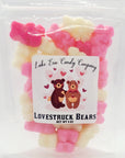 A clear bag labeled "Lake Erie Valentine Candy" from Faire holds a charming assortment of pink, white, and red gummy bears—perfect Valentine sweets to share. The bag features cute bear cartoons surrounded by hearts.