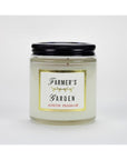 The Austin Press Travel Candle by Faire features a clear glass jar with a black lid, gold, black, and red text on white, and is made with botanical waxes for an all-natural candle experience.