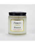 The Austin Press Travel Candle by Faire features a clear glass jar with a black lid, gold, black, and red text on white, and is made with botanical waxes for an all-natural candle experience.