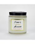 A glass jar Austin Press Travel Candle by Faire features a black lid, “Fawn’s Meadow” in bold, and “Austin Press SF” in red. The jar contains pale botanical waxes for an all-natural candle experience.