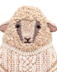 The Faire Sheep Embroidery Kit features a detailed sheep design with textured beige and cream wool, black eyes, and a simple expression on white—ideal for DIY embroidery enthusiasts or embroidered doll kit collections.