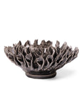 The Fractal Black Flower by Chive Ceramics (thru Faire) is a handmade pottery bowl with a dark, textured finish and sculpted, petal-like edges reminiscent of a blooming flower, shown against a white background.