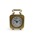 The Zentique PC115 Gold Table Clock Pewter features Roman numerals and a decorative handle, blending vintage charm with modern decor. Shown against a plain white background.