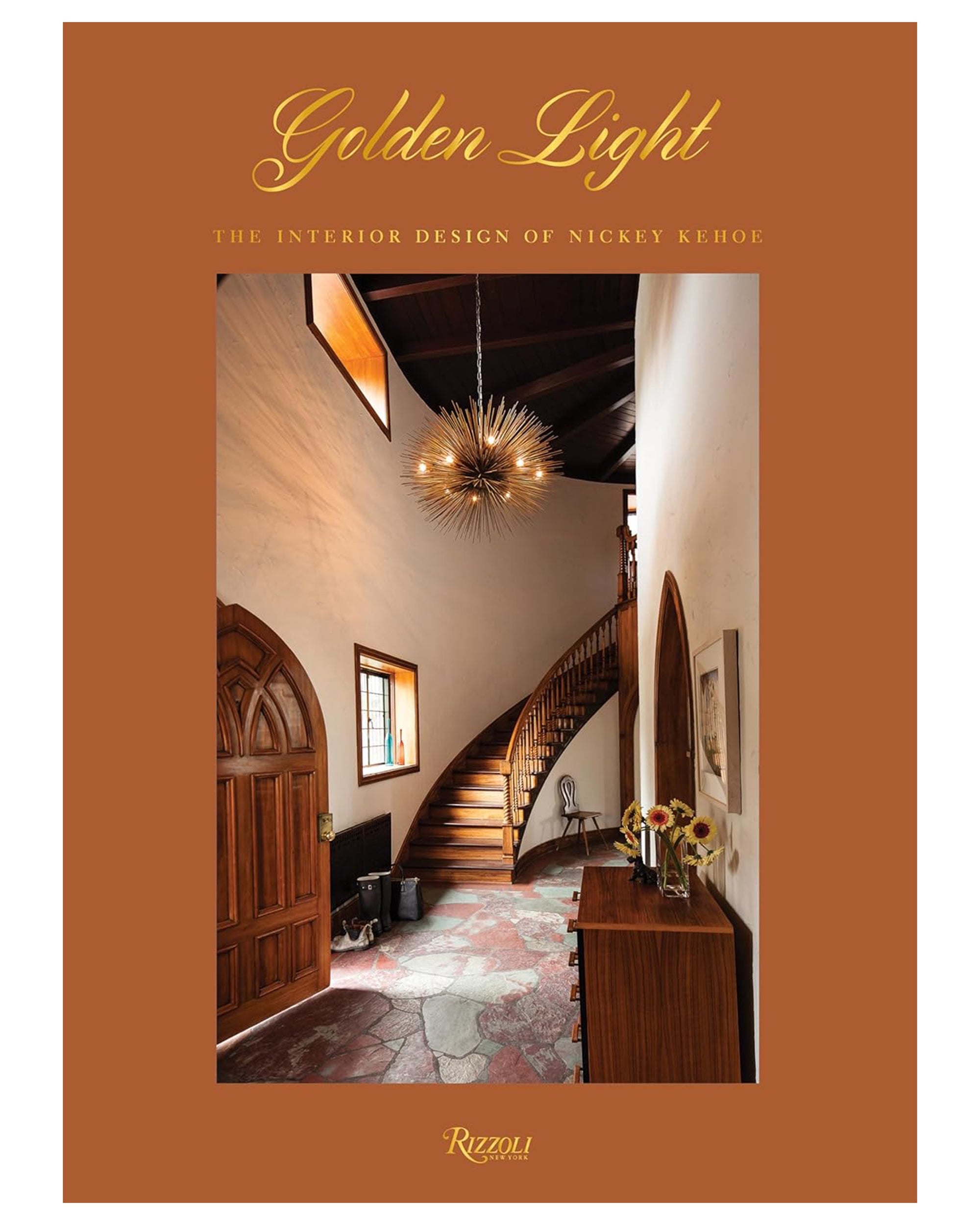 Book cover for Golden Light by Random House, featuring a warm-toned photo of an elegant entryway with a curved staircase, arched doors, and a modern chandelier.