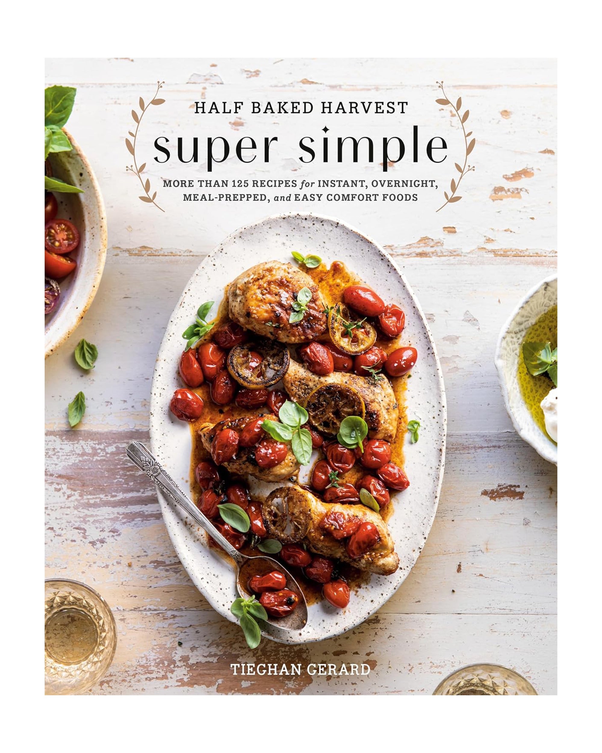 Cover of "Half Baket Harvest Super Simple" by Random House, showing a white oval plate of chicken with roasted tomatoes and basil on a rustic background—ideal for comfort food fans and easy recipe lovers.