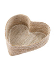 The Indaba Heart Seagrass Basket is a shallow, heart-shaped tray crafted from woven natural fibers—an ideal accent piece to showcase on a white background.