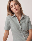 Short sleeve Hunter Stripe shirt by THE SHIRT, gold hoop earrings, and watch styled on woman looking at camera.