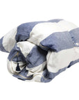The Hedgehouse Throwbed features a blue and white striped, soft cotton removable cover with a visible zipper and black tassel. This cozy bedding is rolled up for convenience and the machine-washable cover makes care easy.