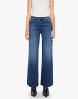 Blue stretch denim jeans with black boots, Mother brand, The Hustler Roller Sneak style, shown from shoulders down.