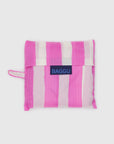 The Baggu Standard by Baggu, a folded reusable bag with vertical pink and white stripes made from recycled ripstop nylon, features a blue Baggu label on the front and is shown against a plain light background.