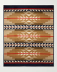 The Pendleton/Babbitt's Wholesale Jacquard Robe is a USA-made wool blanket with a geometric, Native American-inspired pattern in tan, brown, navy, red, and cream, featuring symmetrical triangles and diamonds.
