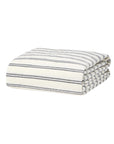 The Kemptown Stripe Linen Duvet by Faire features a neatly folded ivory cover with thin, evenly spaced horizontal black and gray stripes.
