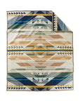 The Jacquard Robe by Pendleton/Babbitt’s Wholesale features a geometric triangle and stripe pattern in blue, yellow, green, and tan on cream. Crafted in American mills, one corner is folded to display the reverse side.