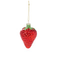 The Juicy Ornament by Accent Decor is a shiny red glass strawberry with green leaves, measuring 2.25 x 2.25 x 3.0 inches, hanging from a thin gold string against a plain white background.