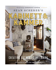 Cover of "Sean Scherer's Kabinett" by Hachette Book Group, showcasing an eclectic living room with vintage finds, animal decor, and illustrated wallpaper—perfect for interior design fans. Features a foreword by Anderson Cooper.
