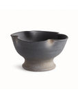 The N4TQ10 Kaloa Bowl by Napa Home & Garden is a handcrafted black ceramic piece with a cold finish, featuring an uneven wavy rim and wide rounded base—ideal for display against any plain white background.