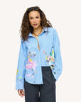 Blue striped Kerri Rosenthal Mia Happimess shirt styled with gray pants and gold necklace, casual modern look.