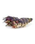 The Faire Lavender, Sage and Rose Smudge features dried sage, lavender, and rose tied with twine—an ideal choice for gentle cleansing rituals.