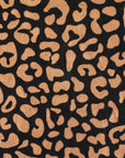 Close-up of Typical’s Wild Leopard Bath Towel fabric, featuring irregular tan spots on a black background for a bold, stylish look.