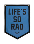 A blue Oxford Pennant flag with black trim, bold black "LIFE'S SO RAD" text, and a small Maladroit-era =W= logo near the bottom. Product name: Life's So Rad.