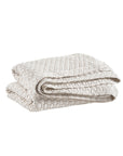 The Pinecone Hill Lodi Matelasse Coverlet is a light beige, waffle-knit blanket with a textured pattern, shown folded against a white background.