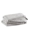 The folded Lodi Matelassé Coverlet by Pinecone Hill features a light gray color, raised dot pattern, and soft cotton layer, displayed on a white background.