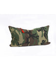 The Hedgehouse Lumbar Pillow 14x26 features a green, brown, and black camouflage pattern with a small red tag on the top left, made of comfortable, washable cotton. Shown against a plain white background.
