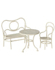 White metal bench, round table, and chair with curved designs from Maileg Café Set Small at Bungalow Furniture & Accessories.
