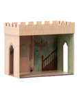 The Maileg Castle Hall by Maileg is a miniature model with open sides, painted stone walls, arched doorways, a staircase, chandelier, and wallpaper—ideal for magical tea parties or royal adventures.