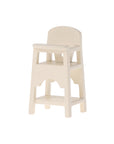 The Maileg High Chair by Maileg is a small, cream-colored chair with a simple backrest and footrest, ideal as dollhouse furniture or for baby mice accessories, shown against a plain white background.