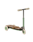 The Maileg Kick Board by Maileg is a children's scooter with a wooden deck, light green handlebar and wheels, plus white accents, displayed against a plain white background.