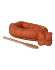 The Maileg Rubber Boat features a small orange design with yellow bands, a matching rolled-up bundle, and a wooden paddle—ideal for adventurous hiker mice and photographed on a white background.