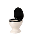 A small white Maileg Water Closet with a black seat and lid, shown open on a plain white background—ideal for compact Maileg bathrooms or as a whimsical mouse toilet display.