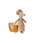 The Maileg Wellness Mouse / Big Sister by Maileg wears a striped towel and matching shower cap, standing beside a gold-colored cup on a white background—a delightful addition to any mouse playset.