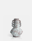 The AA-M9-001 Marilla Vase by Abigail Ahern is a decorative ceramic piece with a rounded body, narrow neck, and two ornate handles featuring circular cutouts. Its marbled red and white surface stands out against a plain white background.