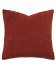 Rust-colored square pillow with boucle texture, indented top corners, by Eastern Accents, MARL Brick collection.