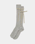 The Maria La Rosa College Velvet Bow Sock features long, light gray ribbed socks with beige velvet ribbon bows at the upper cuffs, shown on a plain white background.